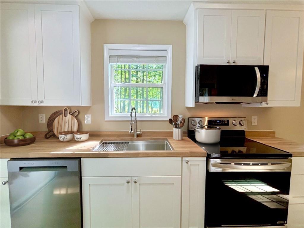 413 Old Brock Road Rockmart, GA 30153 - Photo 3 of 27 a kitchen with a sink stove and microwave
