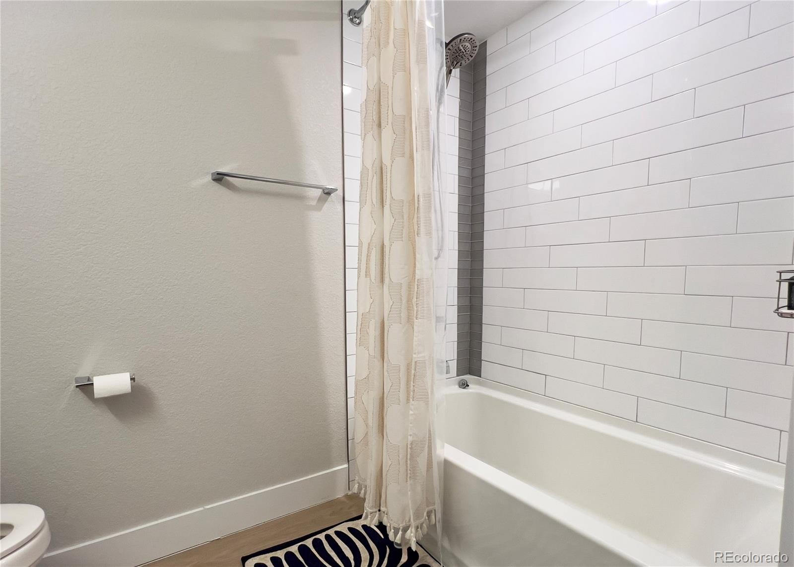 6228 West 38th Avenue Wheat Ridge, CO 80033 - Photo 29 of 38 a bathroom with a bathtub