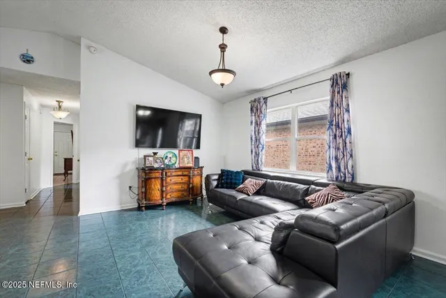 a living room with furniture and a flat screen tv