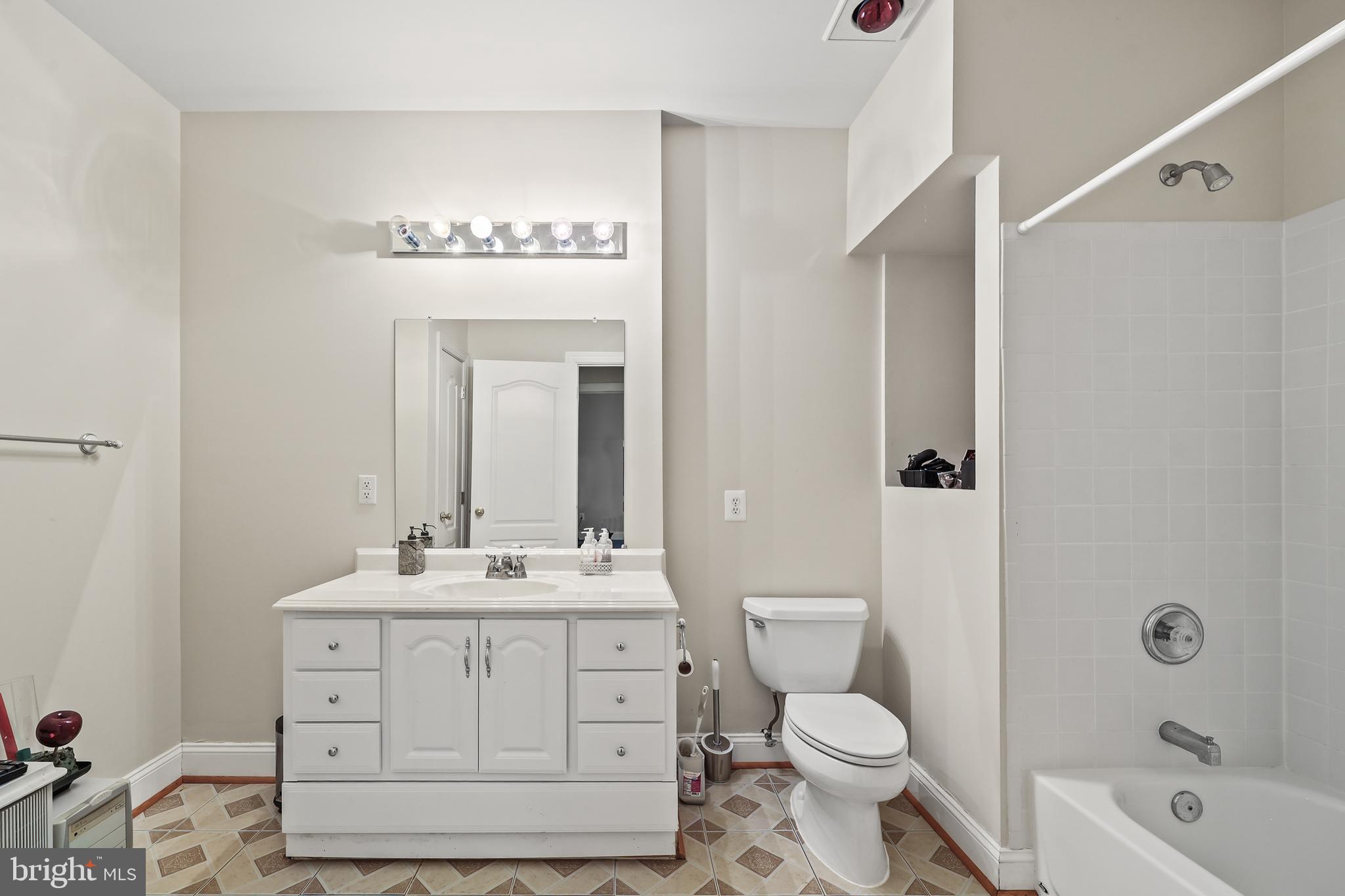40890 Beechnut Road Leesburg, VA 20175 - Photo 43 of 65 a bathroom with a sink a toilet and shower