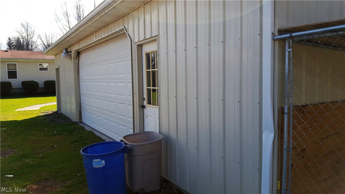 7444 Pettibone Road Chagrin Falls, OH 44023 - Photo 24 of 29 garage man door to office and another mad door and double garage door to the garage...dog pens off rear