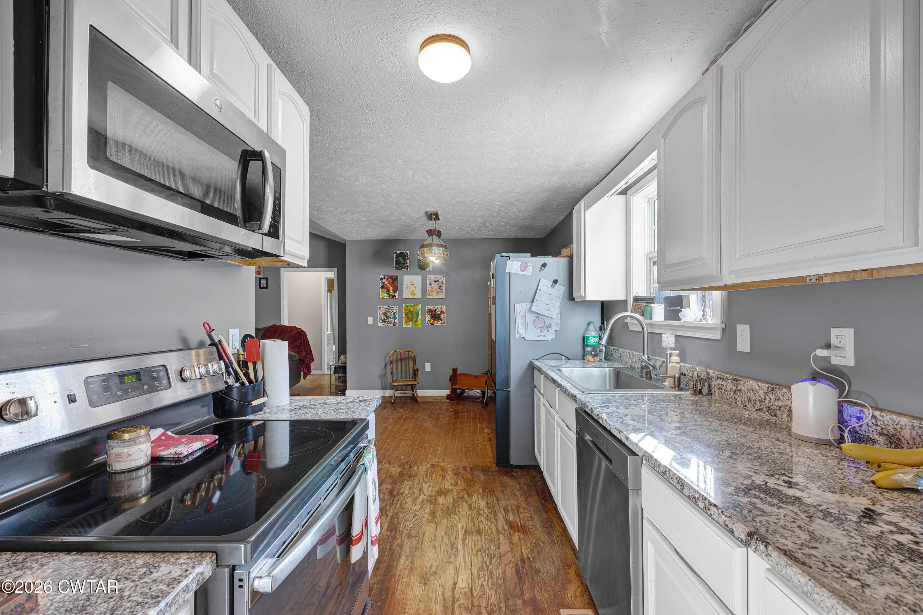 392 Howley Lane Cedar Grove, TN 38321 - Photo 7 of 14 a kitchen with stainless steel appliances granite countertop a sink stove and cabinets
