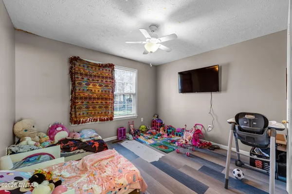 a bedroom with a bed and a chandelier