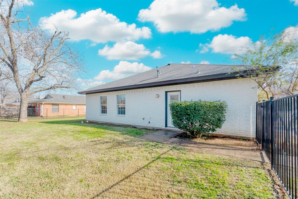 216 East Walcott Street Pilot Point, TX 76258 - Photo 10 of 12 a view of a house with a big yard and potted plants