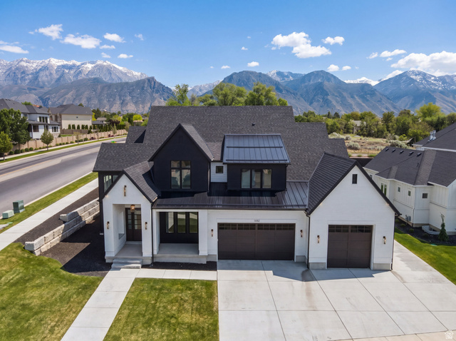 1682 North 1950 W Street, Unit 9 Provo, UT 84604 - Photo 2 of 84 Modern Farmhouse architecture featuring white siding with black accents, a dark asphalt shingle roof, and a metal roof dormer