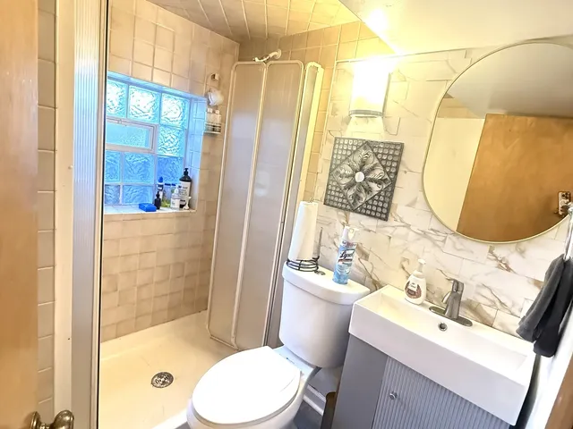 a bathroom with a sink toilet and shower