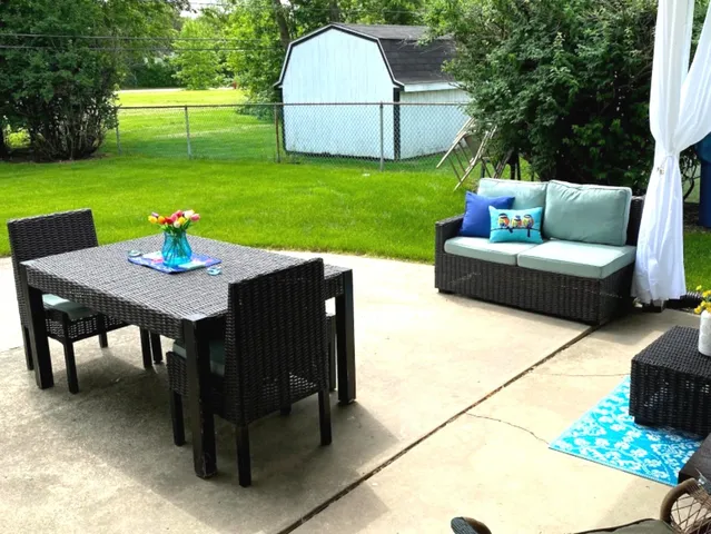 a view of backyard with seating area and green space