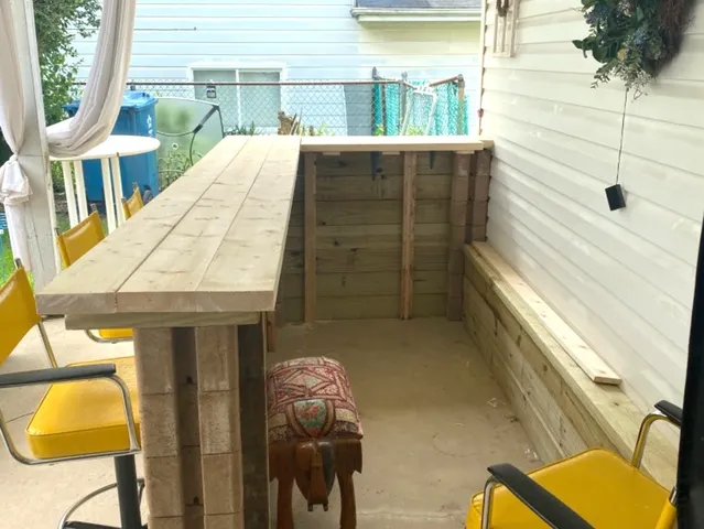 a balcony with table and chairs