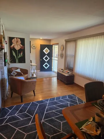 a room with wooden floor and furniture