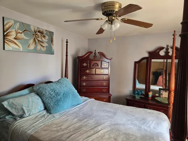 a bedroom with a bed and a painting on the wall
