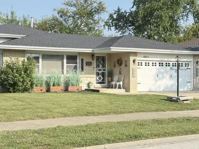 a view of a house with a big yard and large trees