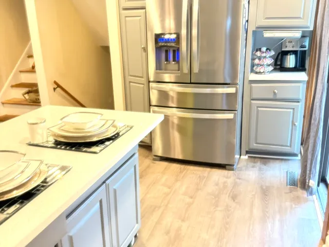 a kitchen with stainless steel appliances granite countertop a sink and a refrigerator