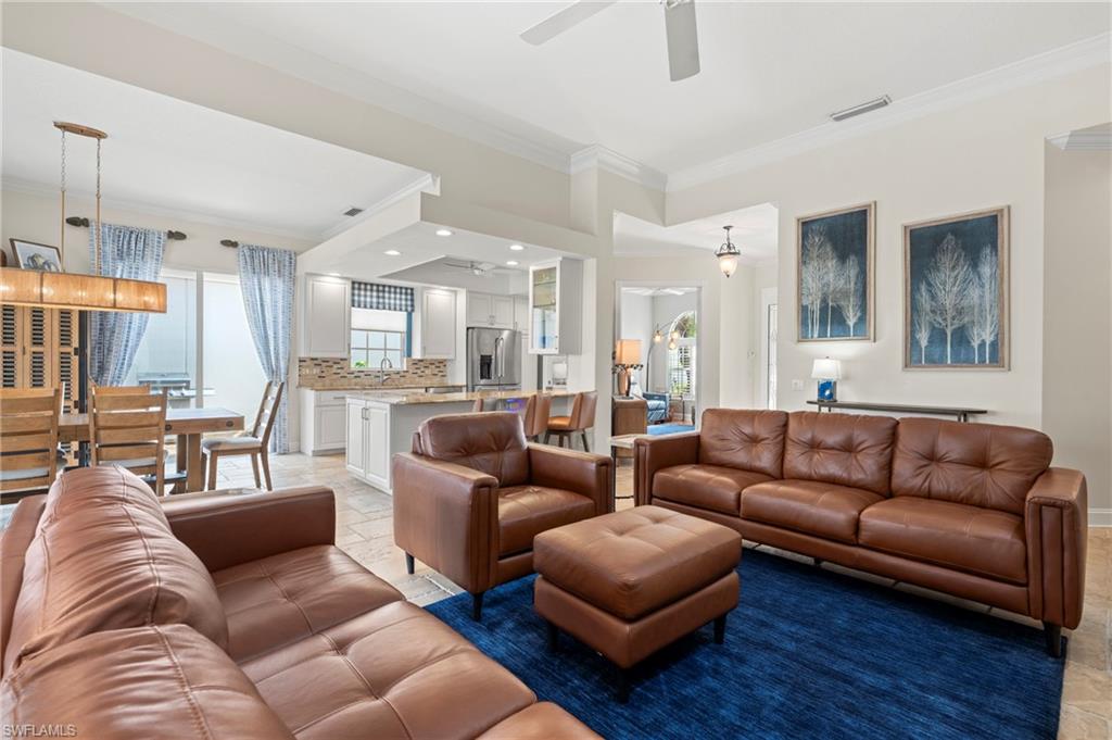 4401 Novato Court Naples, FL 34109 - Photo 12 of 50 a living room with furniture wooden floor and a large window