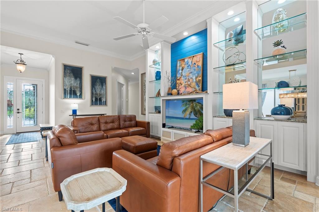 4401 Novato Court Naples, FL 34109 - Photo 13 of 50 a living room with fireplace furniture and a painting on the wall