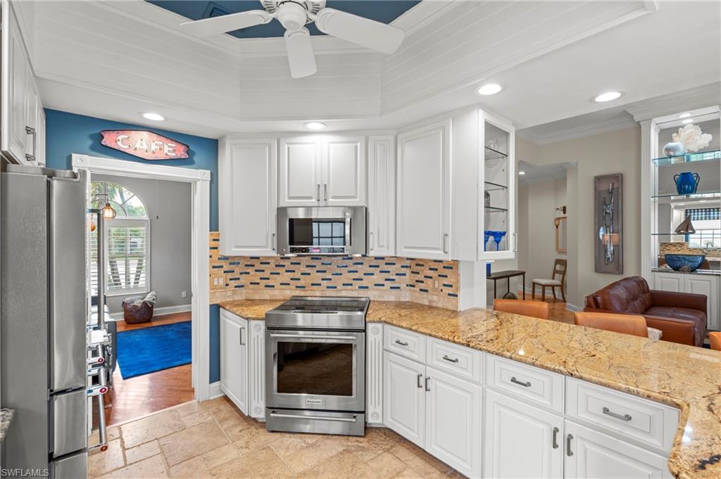 4401 Novato Court Naples, FL 34109 - Photo 15 of 50 a kitchen with granite countertop a sink stainless steel appliances and cabinets