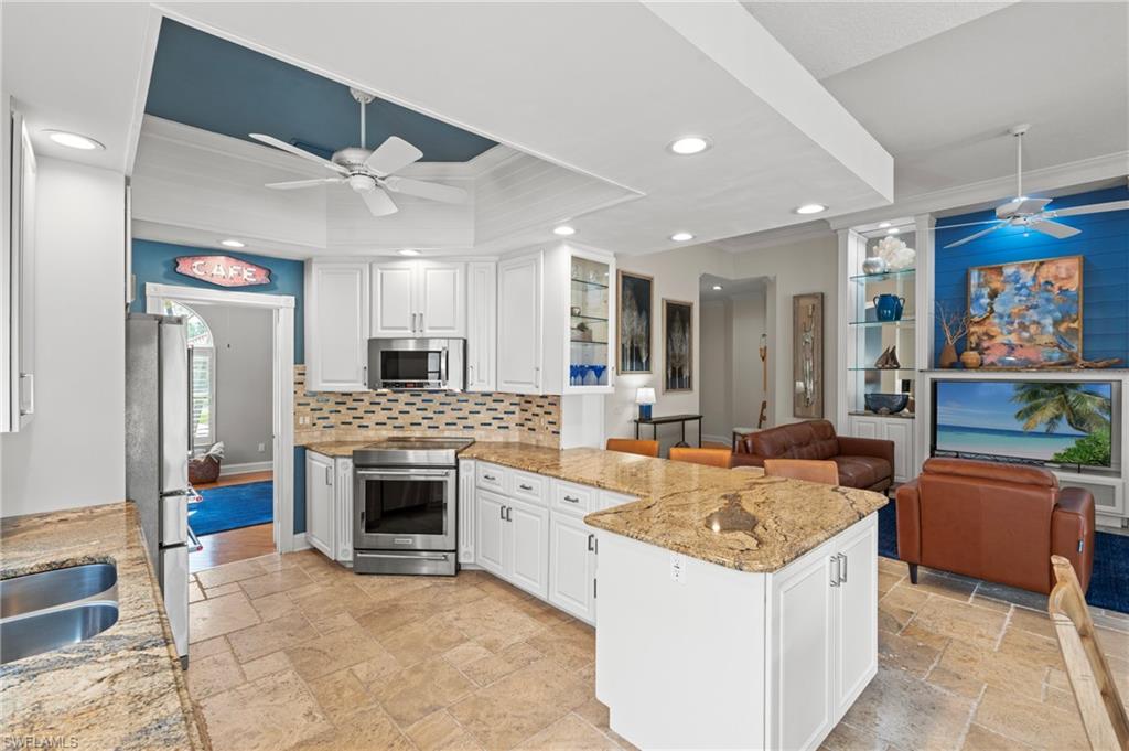 4401 Novato Court Naples, FL 34109 - Photo 17 of 50 a large kitchen with stainless steel appliances granite countertop a stove and a refrigerator