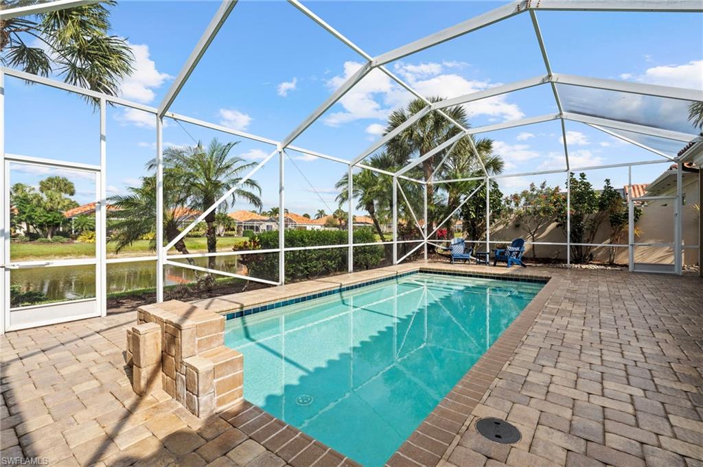 4401 Novato Court Naples, FL 34109 - Photo 2 of 50 a view of a swimming pool with a patio