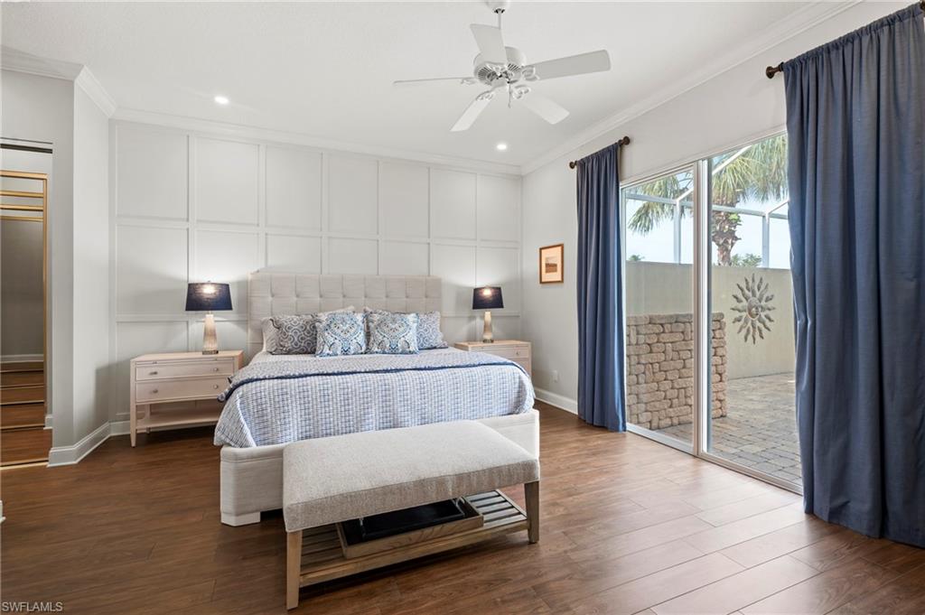 4401 Novato Court Naples, FL 34109 - Photo 21 of 50 a bedroom with a bed and wooden floor