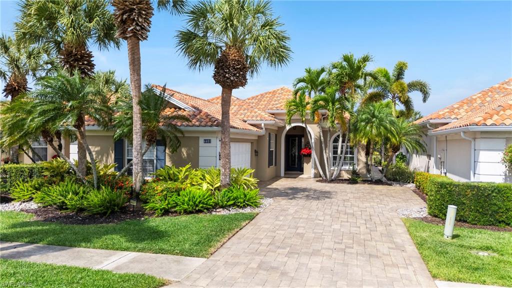 4401 Novato Court Naples, FL 34109 - Photo 3 of 50 a view of a house with a small yard and palm trees
