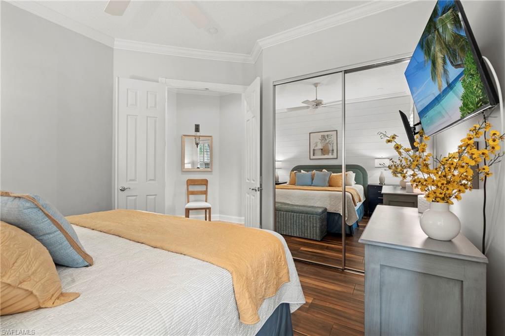 4401 Novato Court Naples, FL 34109 - Photo 31 of 50 a bedroom with a bed and a mirror