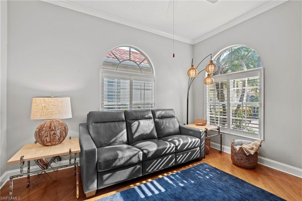 4401 Novato Court Naples, FL 34109 - Photo 32 of 50 a living room with furniture and a large window