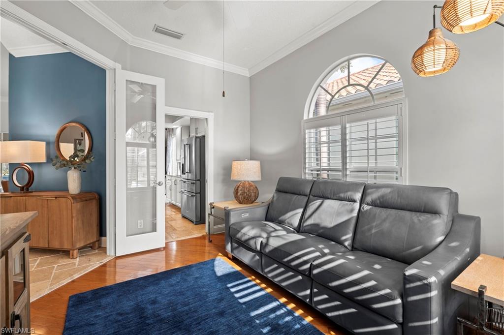 4401 Novato Court Naples, FL 34109 - Photo 33 of 50 a living room with furniture and wooden floor