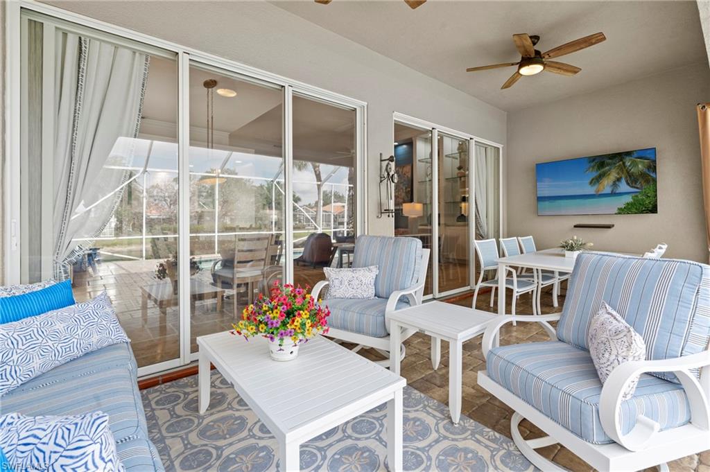 4401 Novato Court Naples, FL 34109 - Photo 39 of 50 a living room with furniture a flat screen tv and a large window