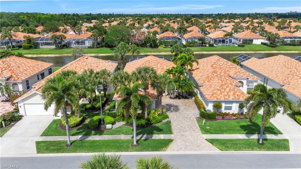 4401 Novato Court Naples, FL 34109 - Photo 4 of 50 an aerial view of a house with a yard and outdoor seating