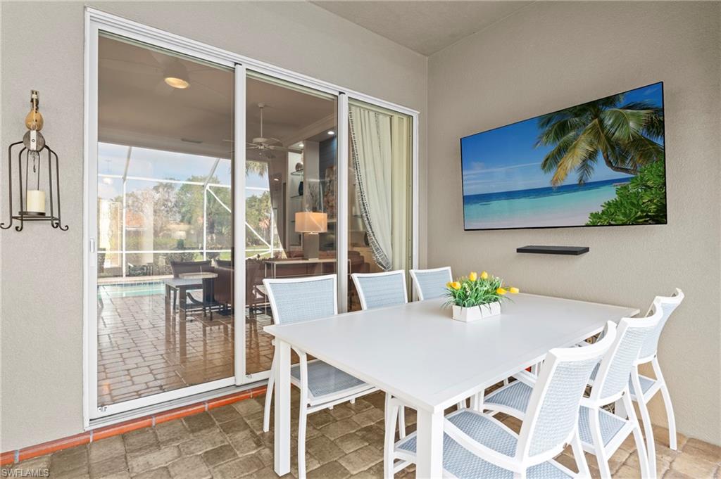 4401 Novato Court Naples, FL 34109 - Photo 41 of 50 a view of a dining room with furniture large window and outside view