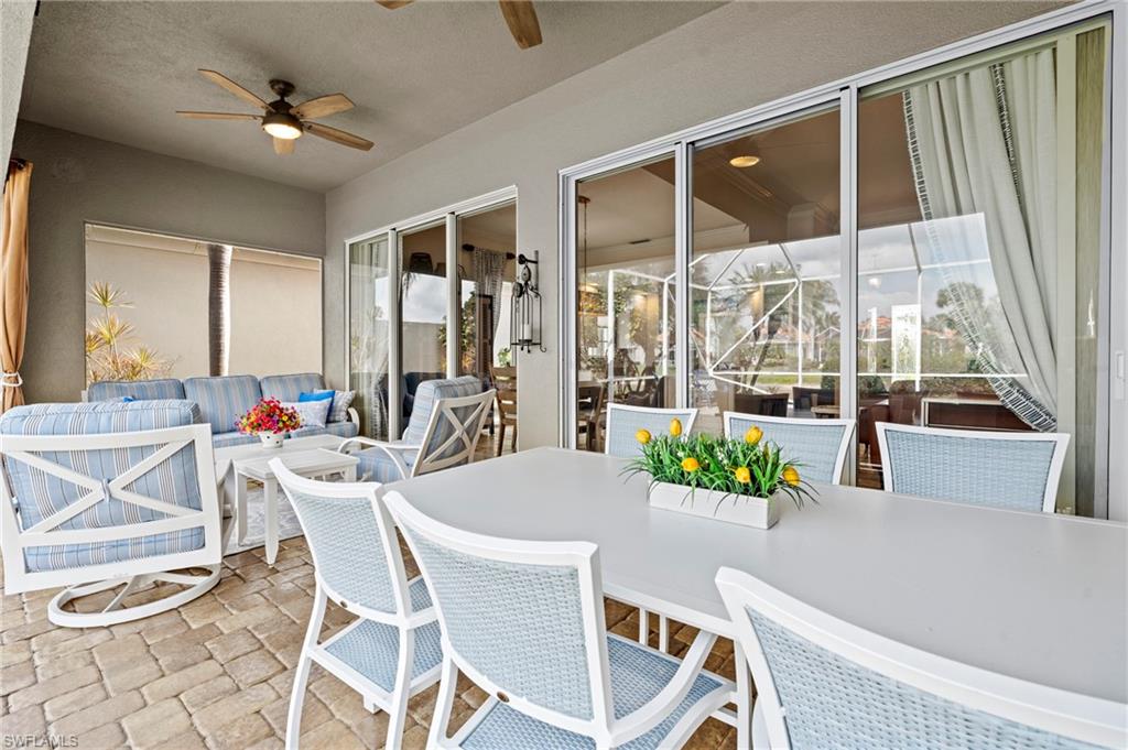 4401 Novato Court Naples, FL 34109 - Photo 42 of 50 a view of a dining room with furniture wooden floor and a chandelier