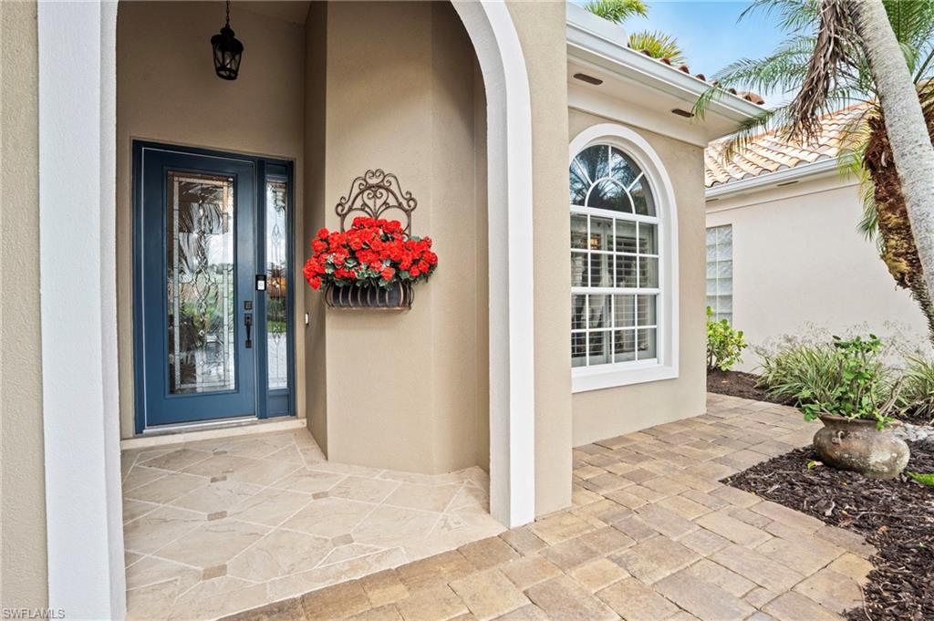 4401 Novato Court Naples, FL 34109 - Photo 6 of 50 a front view of a house with a porch