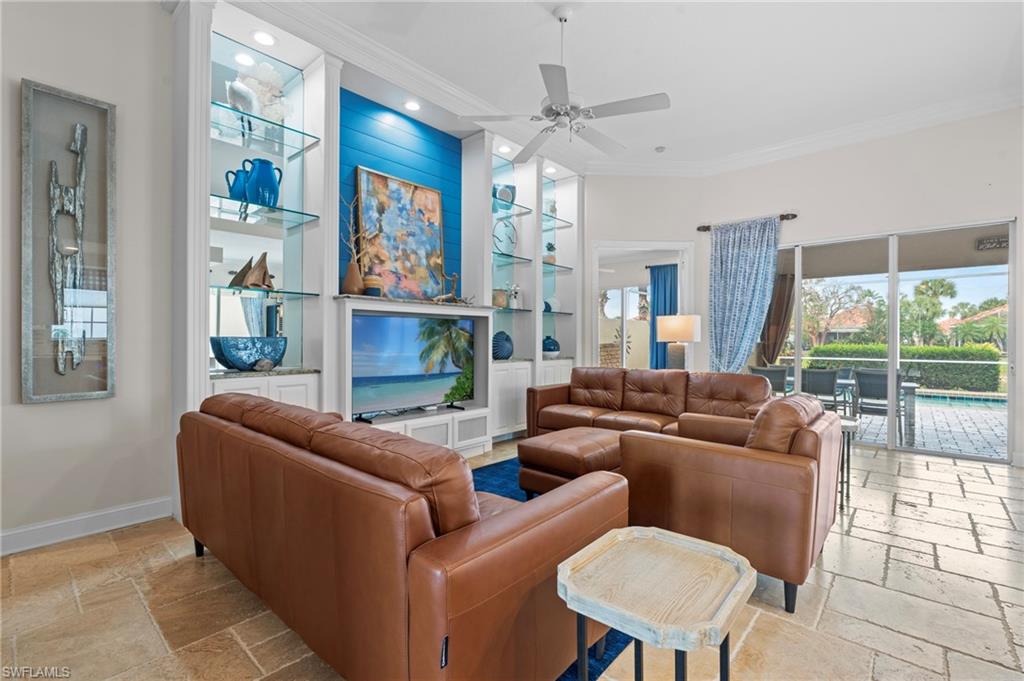 4401 Novato Court Naples, FL 34109 - Photo 9 of 50 a living room with fireplace furniture and a large window