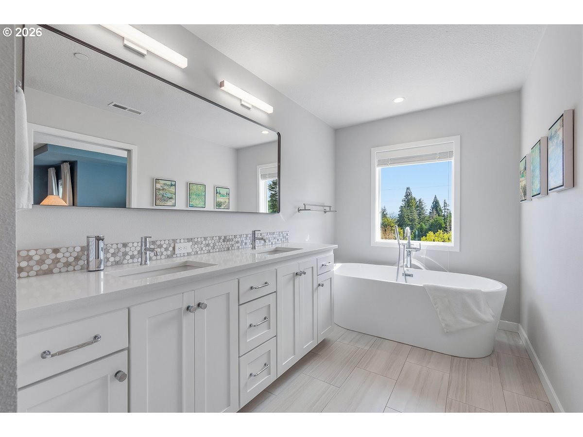 16275 Southwest Jade View Way Beaverton, OR 97007 - Photo 17 of 34 a spacious bathroom with a granite countertop sink mirror and bathtub