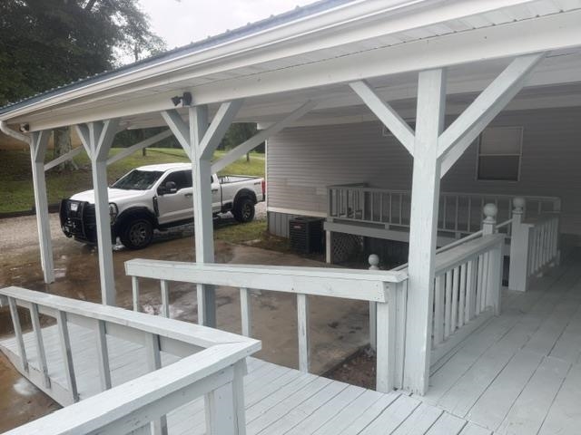 1100 Pine Top Road Toone, TN 38381 - Photo 31 of 40 Covered carport with white wood-finish support beams and a metal roof