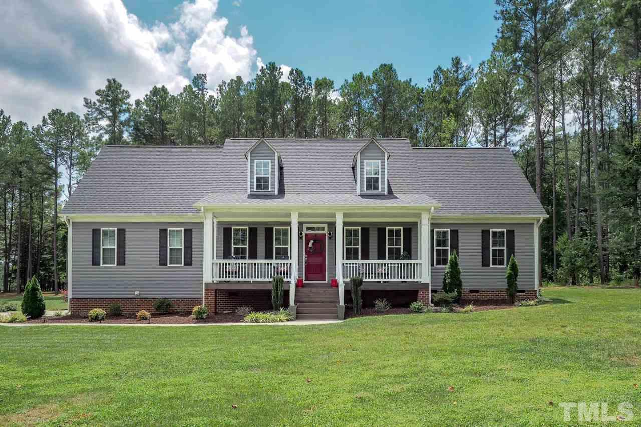 2637 Mt Vernon Church Road Raleigh, NC 27614 - Photo 1 of 15 a front view of a house with a garden and trees