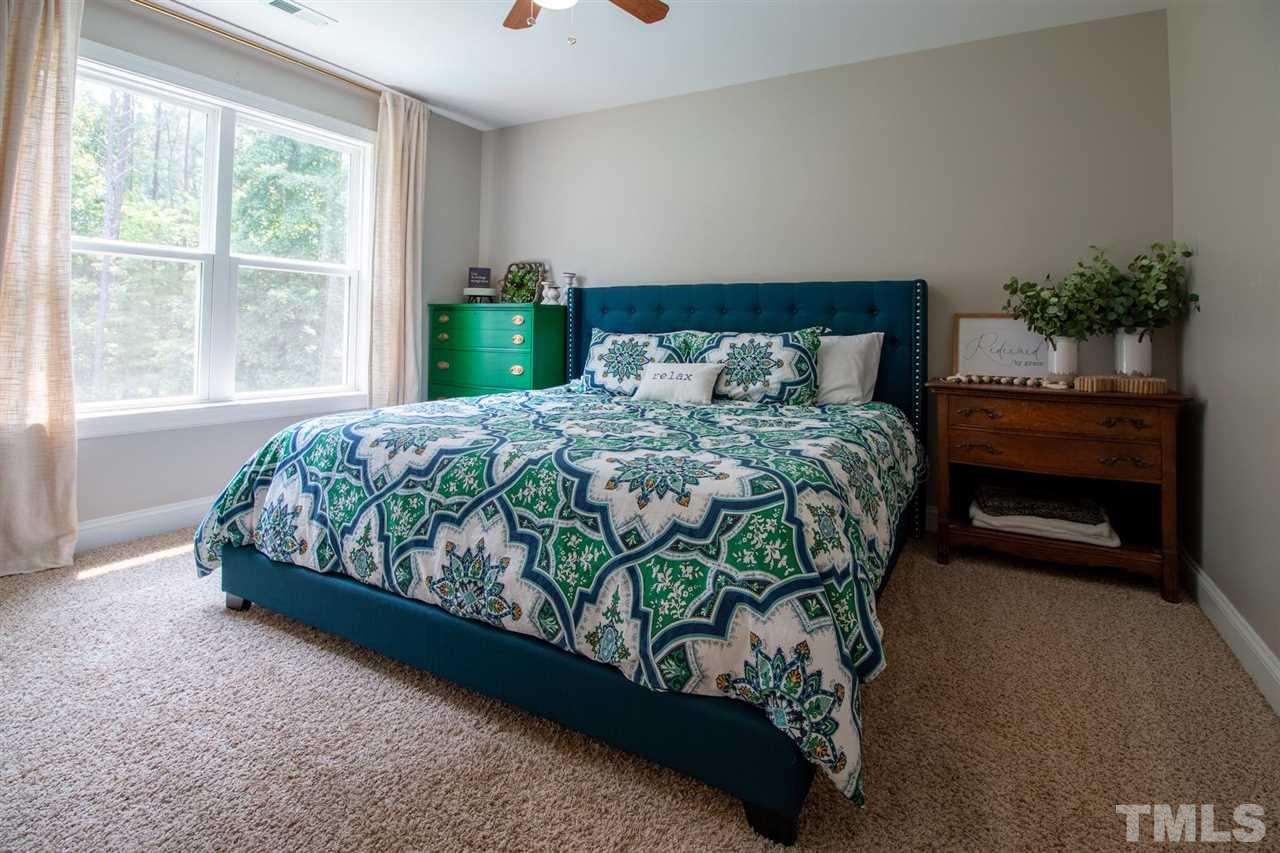 2637 Mt Vernon Church Road Raleigh, NC 27614 - Photo 11 of 15 a bedroom with a bed mirror and a window