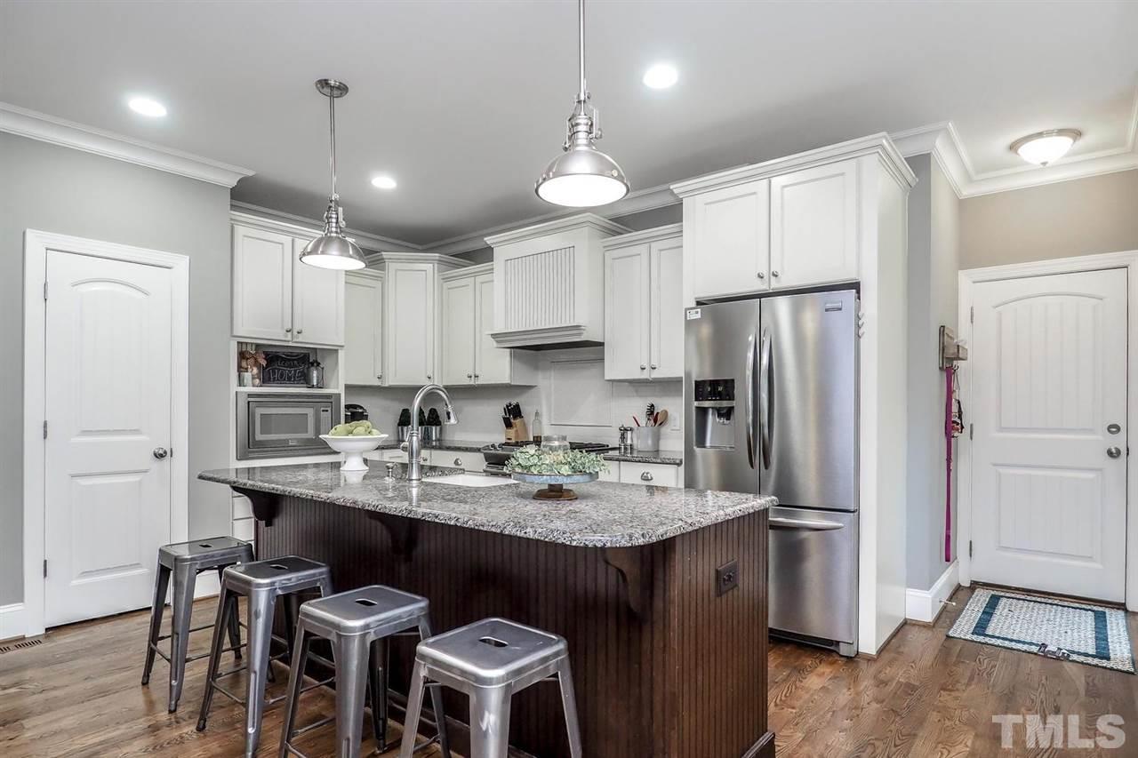 2637 Mt Vernon Church Road Raleigh, NC 27614 - Photo 4 of 15 a kitchen with stainless steel appliances granite countertop a refrigerator a sink dishwasher a stove and white cabinets with wooden floor