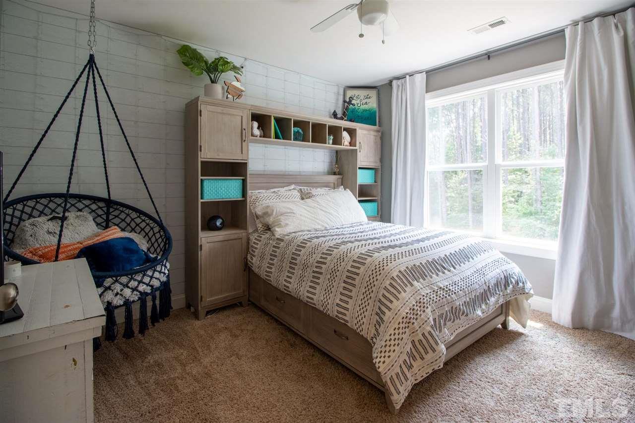 2637 Mt Vernon Church Road Raleigh, NC 27614 - Photo 10 of 15 a bed sitting in a bedroom next to a window