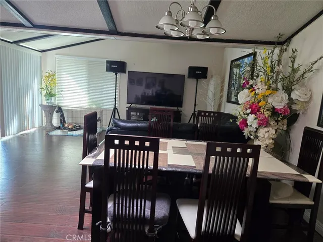 a kitchen with a table chairs refrigerator and cabinets