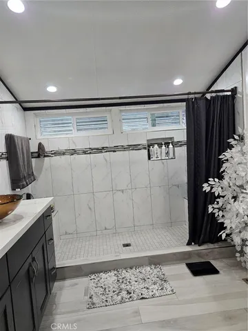 a view of bathroom with a sink and mirror
