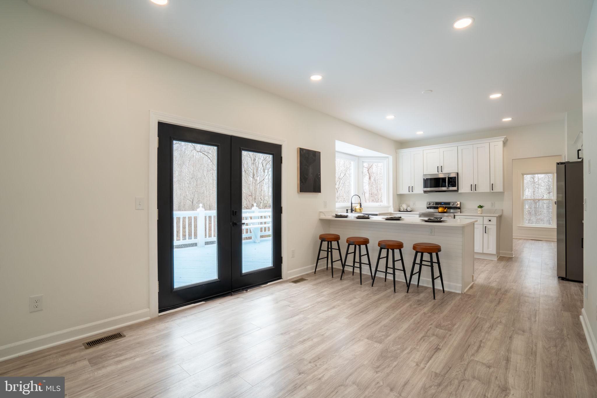 8261 Tinsley Place Culpeper, VA 22701 - Photo 20 of 80 a open kitchen with stainless steel appliances granite countertop a refrigerator and a stove top oven