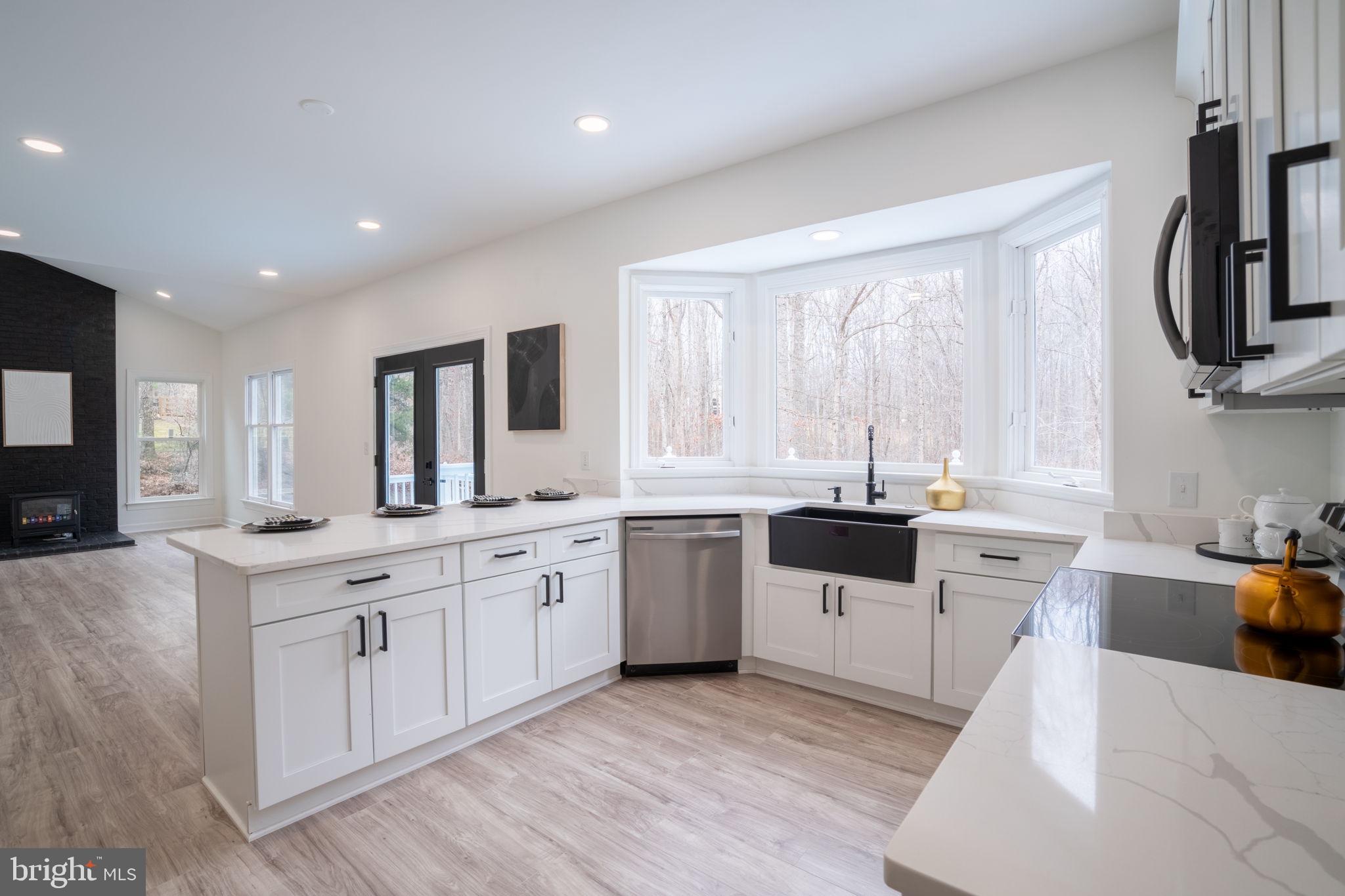8261 Tinsley Place Culpeper, VA 22701 - Photo 23 of 80 a kitchen with a sink a stove and cabinets