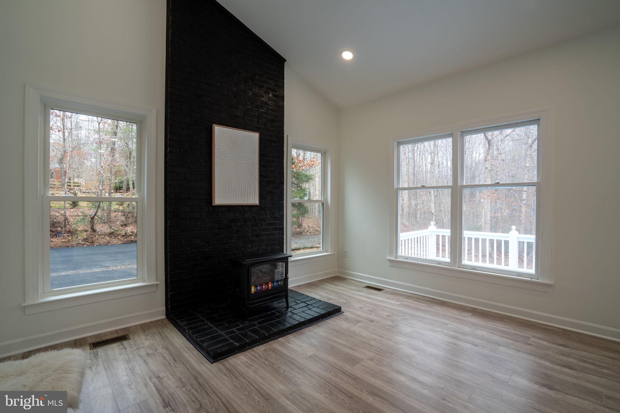 8261 Tinsley Place Culpeper, VA 22701 - Photo 26 of 80 an empty room with wooden floor and windows