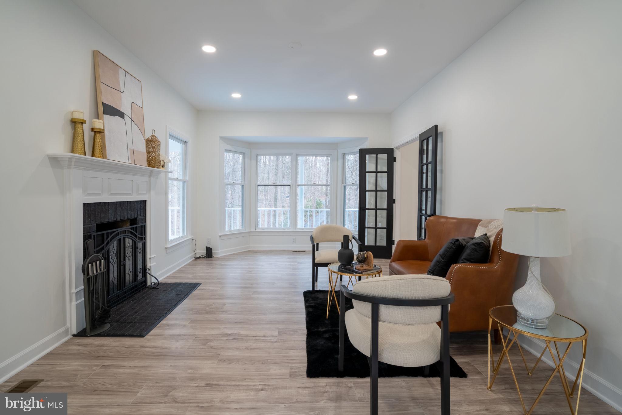 8261 Tinsley Place Culpeper, VA 22701 - Photo 29 of 80 a living room with furniture and a fireplace