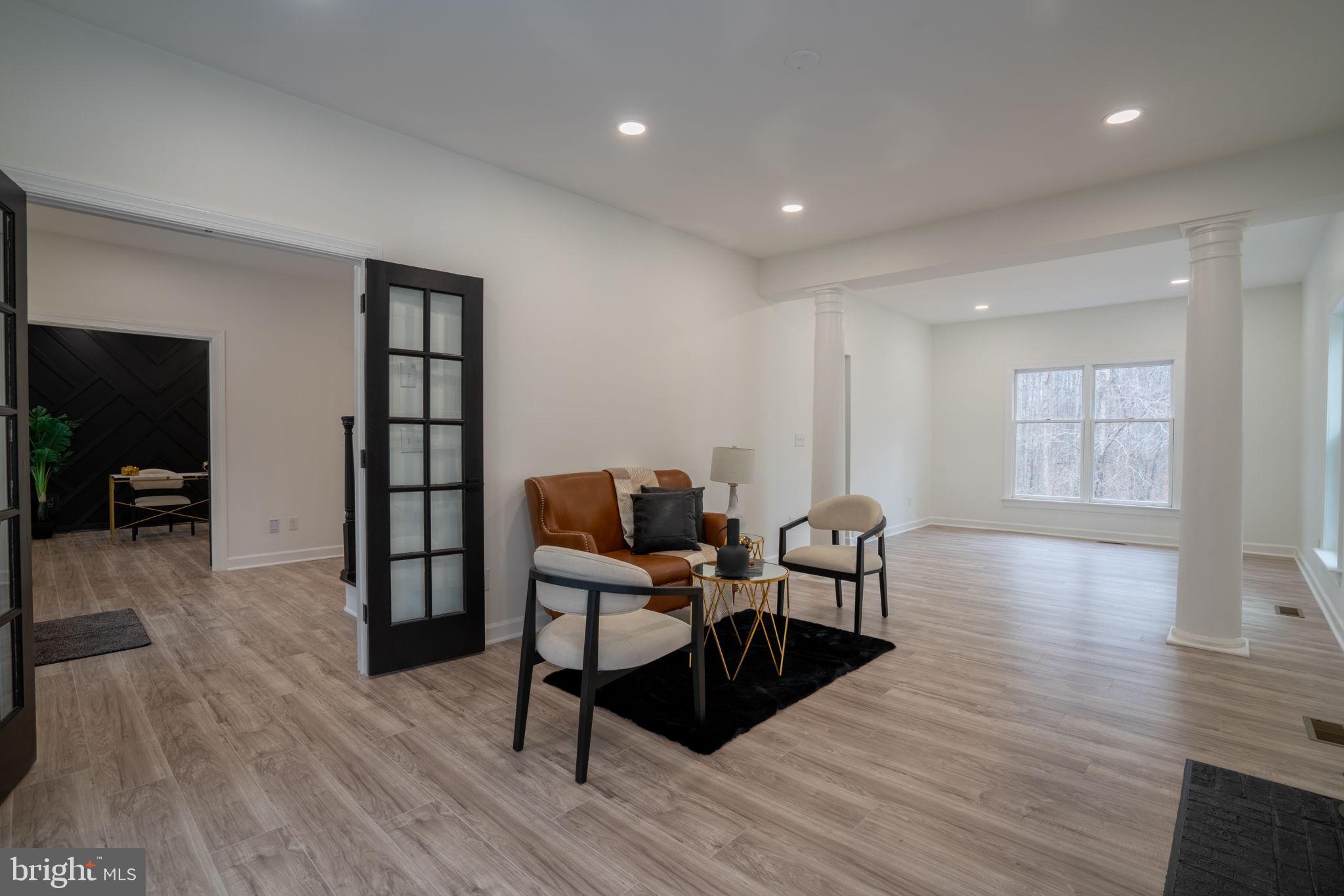 8261 Tinsley Place Culpeper, VA 22701 - Photo 30 of 80 a view of a livingroom with furniture hardwood floor and workspace