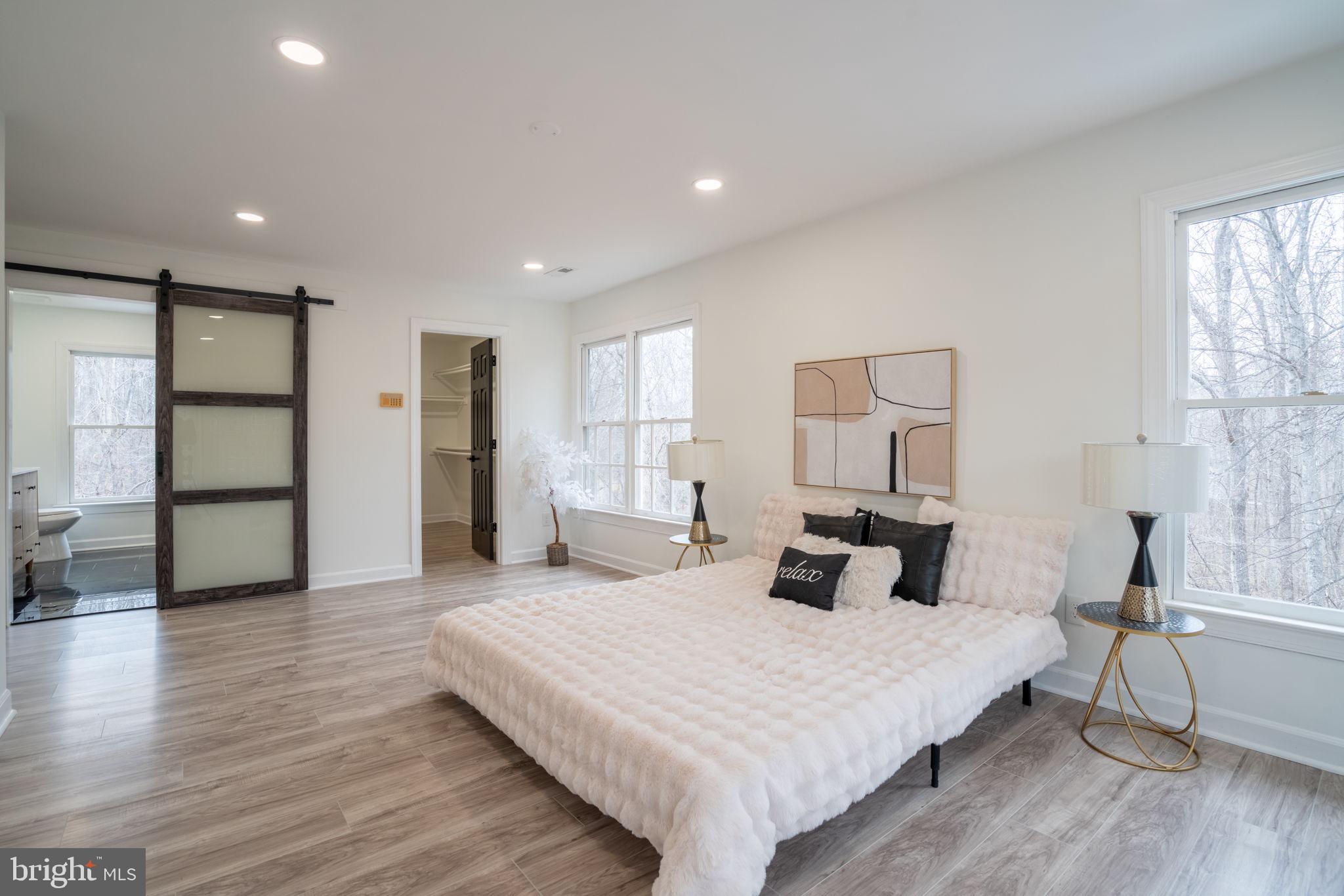 8261 Tinsley Place Culpeper, VA 22701 - Photo 35 of 80 a bedroom with a bed and wooden floor