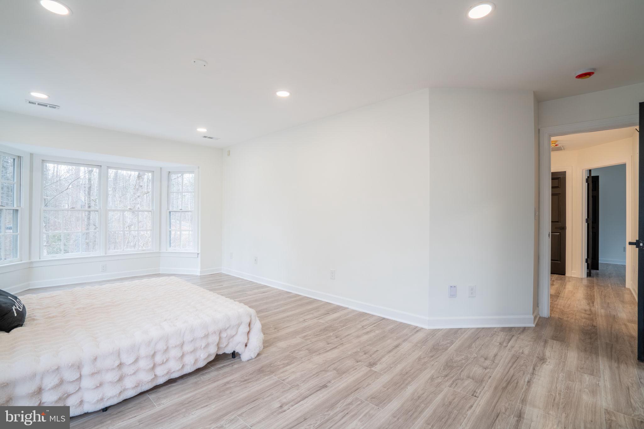 8261 Tinsley Place Culpeper, VA 22701 - Photo 38 of 80 a spacious bedroom with a bed and a large window