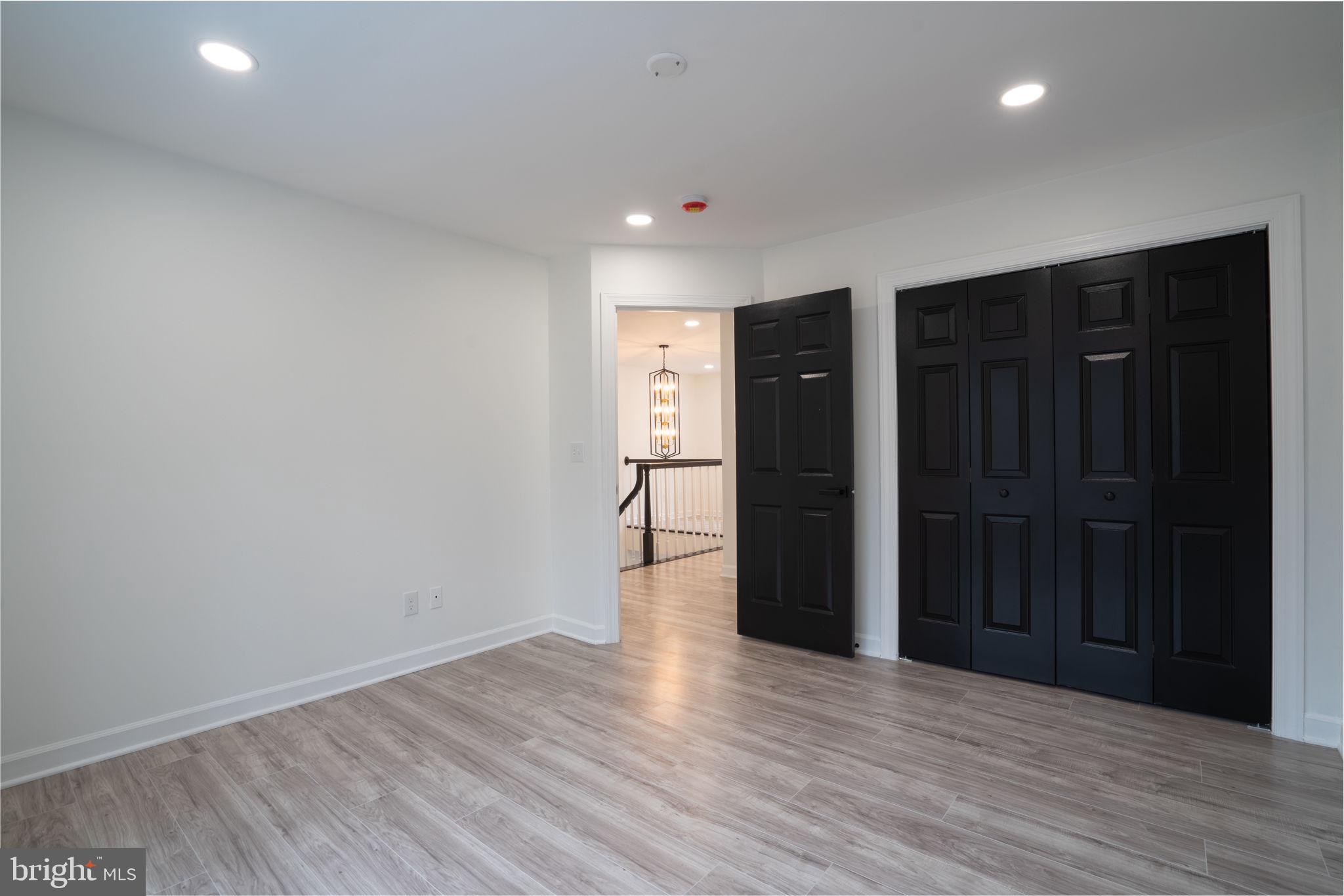 8261 Tinsley Place Culpeper, VA 22701 - Photo 48 of 80 a view of an empty room with wooden floor