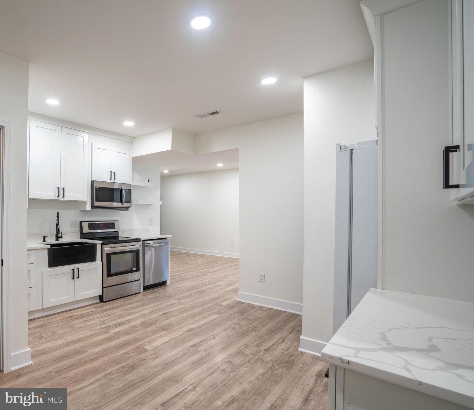 8261 Tinsley Place Culpeper, VA 22701 - Photo 50 of 80 a kitchen with stainless steel appliances kitchen island granite countertop a refrigerator and a stove top oven