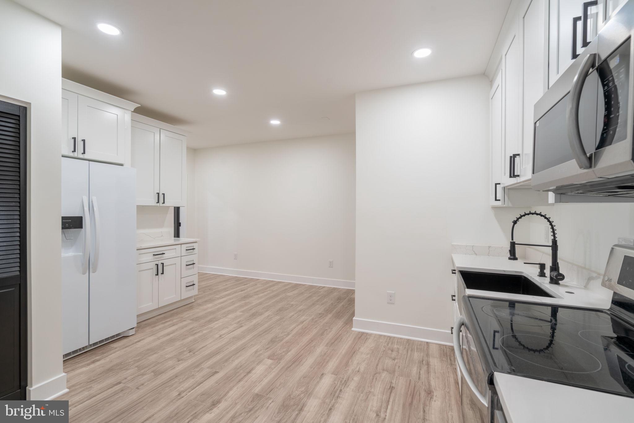 8261 Tinsley Place Culpeper, VA 22701 - Photo 51 of 80 a kitchen with a sink a refrigerator and cabinets